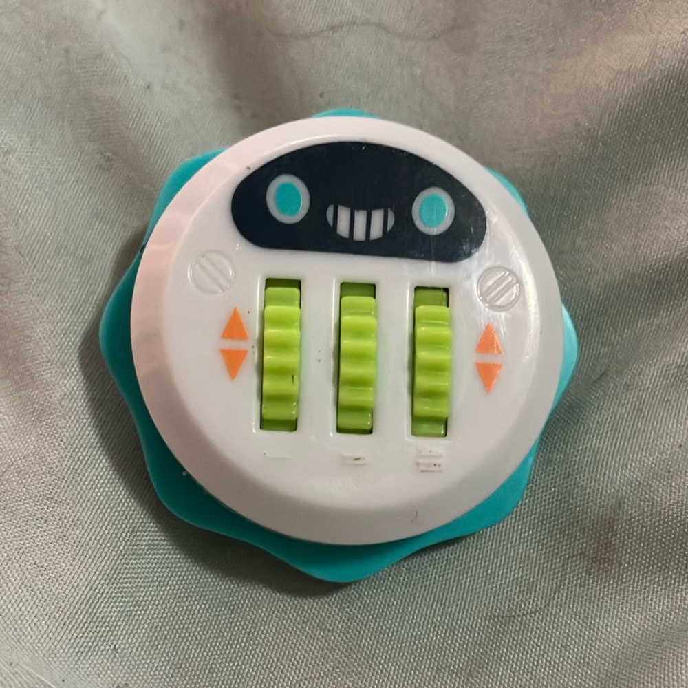 White and Teal Smiley Face Toy